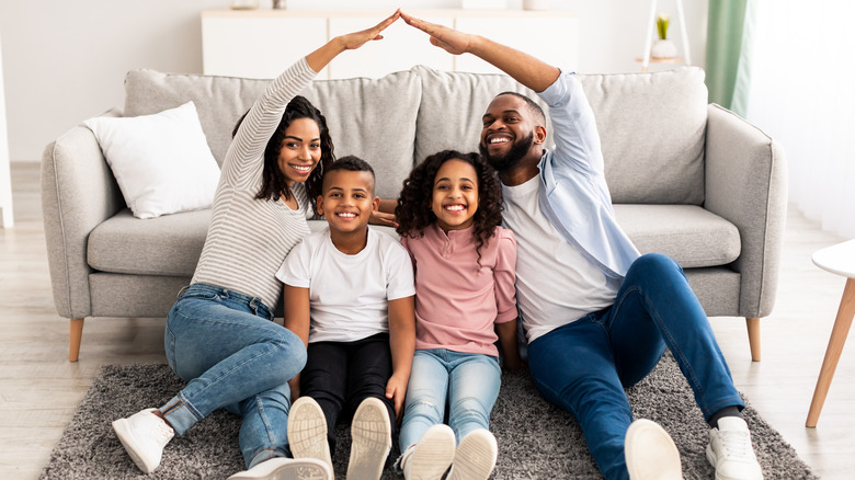 happy family sitting on carpet