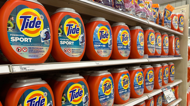 Row of bottles of Procter and Gamble Tide detergent displayed on shelf in a Target retail supermarket
