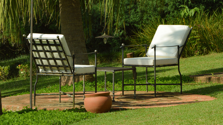 Black cast iron table and chairs in backyard
