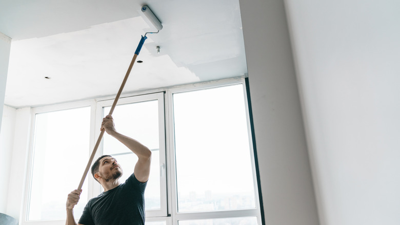 man painting ceiling