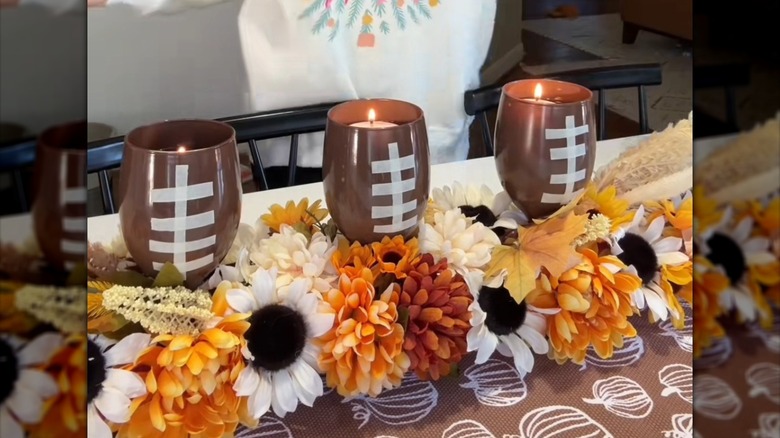 Thanksgiving football centerpiece with faux flowers and tea lights in football glasses