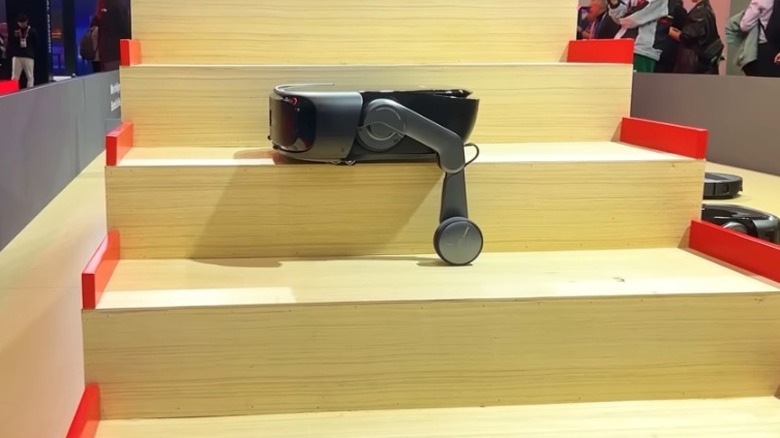 Roborock Saros Rover demonstrating stair-climbing and cleaning functions at CES 2026