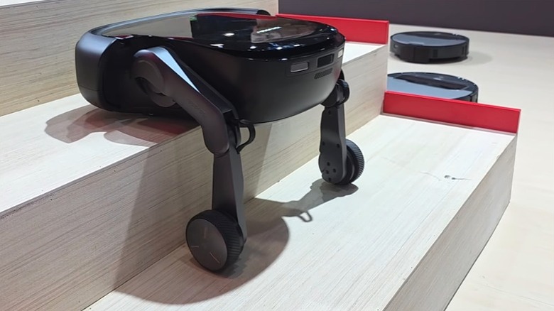 The Roborock robotic vacuum climbs stairs with wheeled legs at CES 2026.