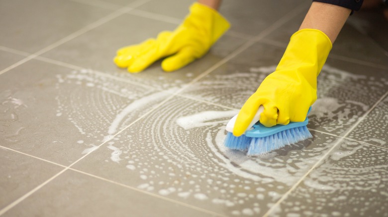 Person cleaning tile floors