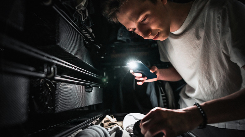 Man looking in dark closet