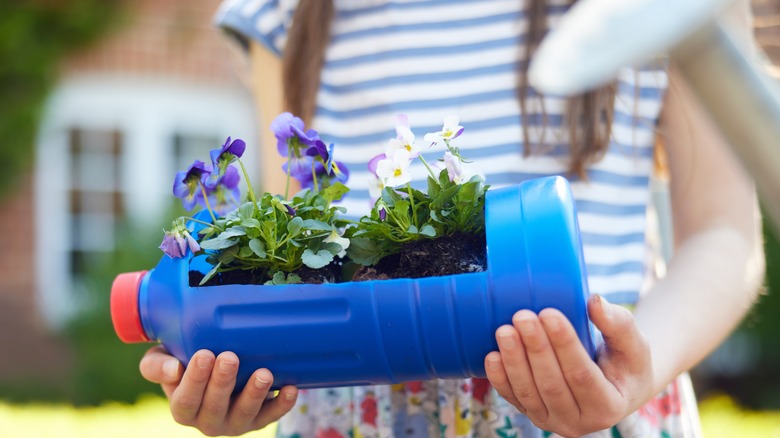 girl holding recycled planter