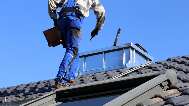 Person on roof to check leak