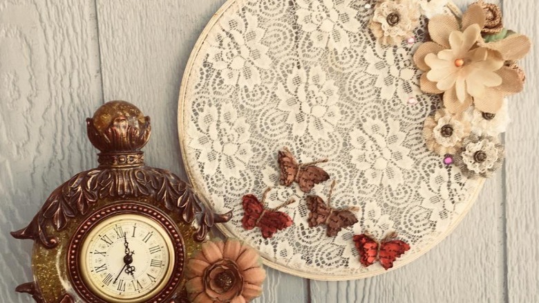 Lace fabric styled in an embroidery hoop with flowers and butterflies