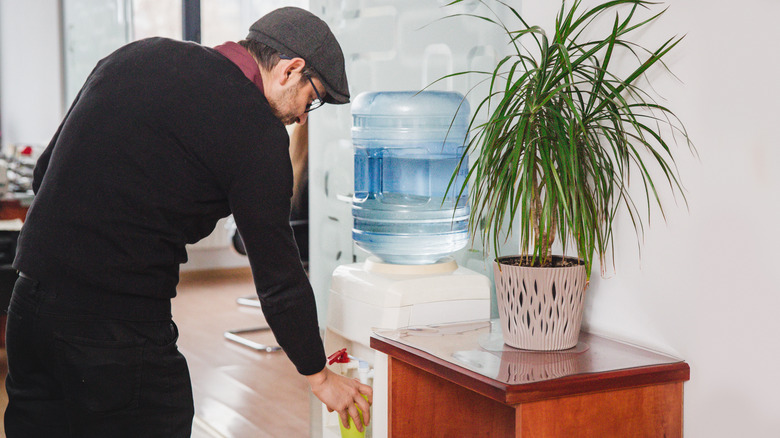 Man collecting water from dispenser