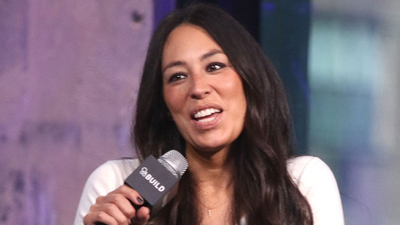 Joanna Gaines speaks into a microphone onstage