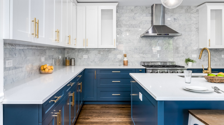 white kitchen with blue base cabinets