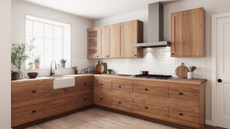 This stylish kitchen features wooden cabinets and modern appliances, creating a bright, inviting space for cooking.