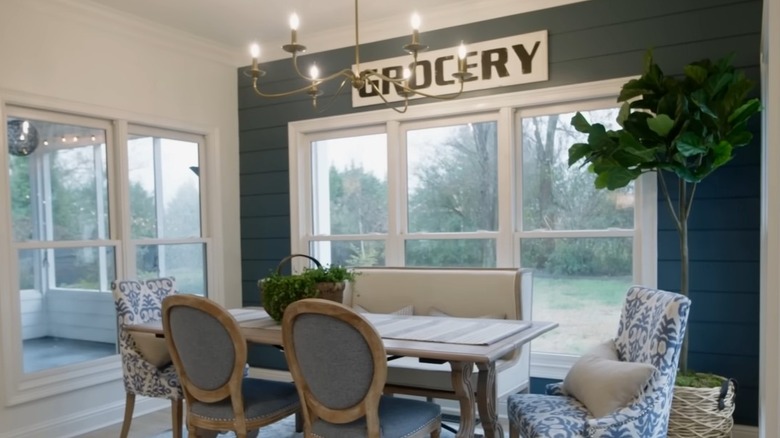 A dark blue shiplap accent wall in a dining nook.