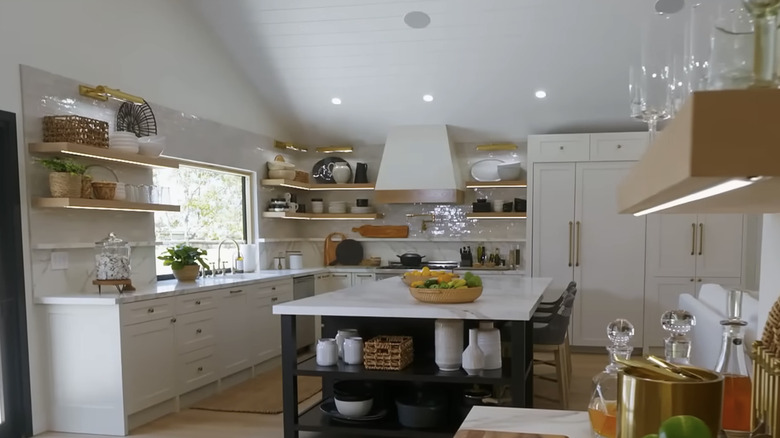 A bright modern kitchen with no upper cabinets.