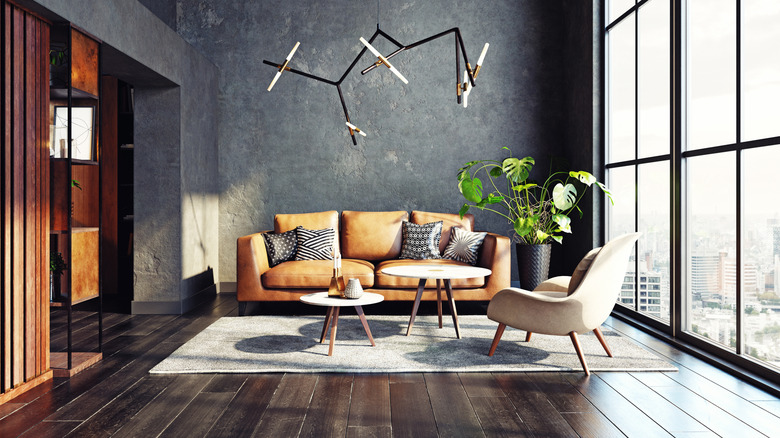 A modern living room with dark flooring.
