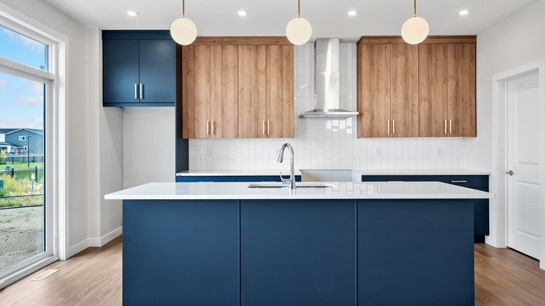 A kitchen with blue cabinetry.