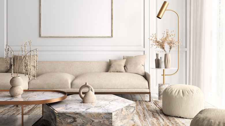 Living room in neutral color palette with soft beige couch and edgy marble coffee table