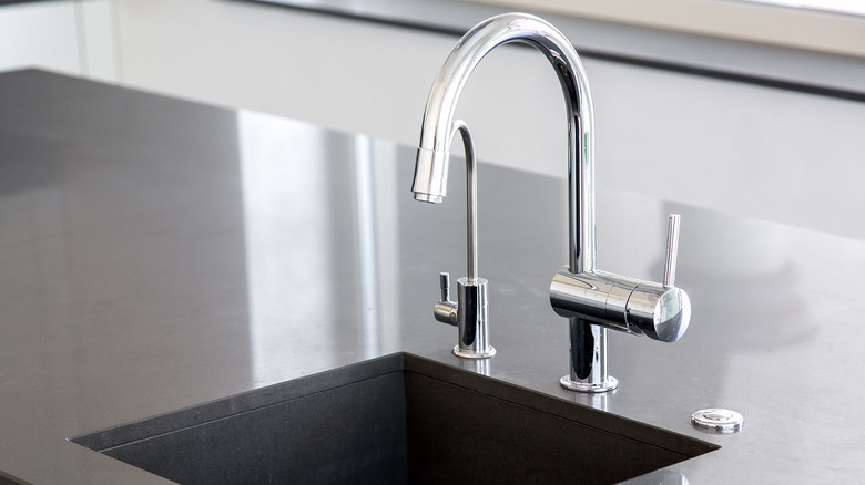 chrome faucet at drainboard sink