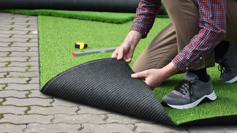 Person installing artificial turf