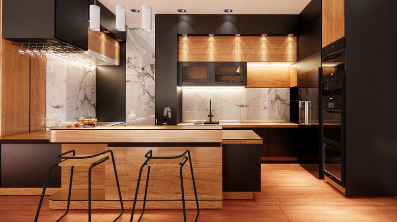 Modern kitchen with black and wood cabinets.