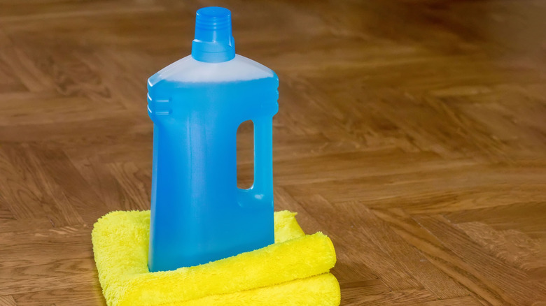 A bottle of cleaning solution on a floor
