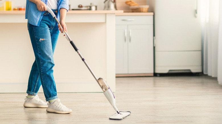 A person mopping a laminate floor