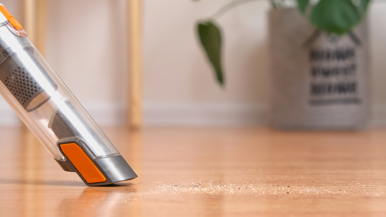 cleaning floor with vacuum attachment