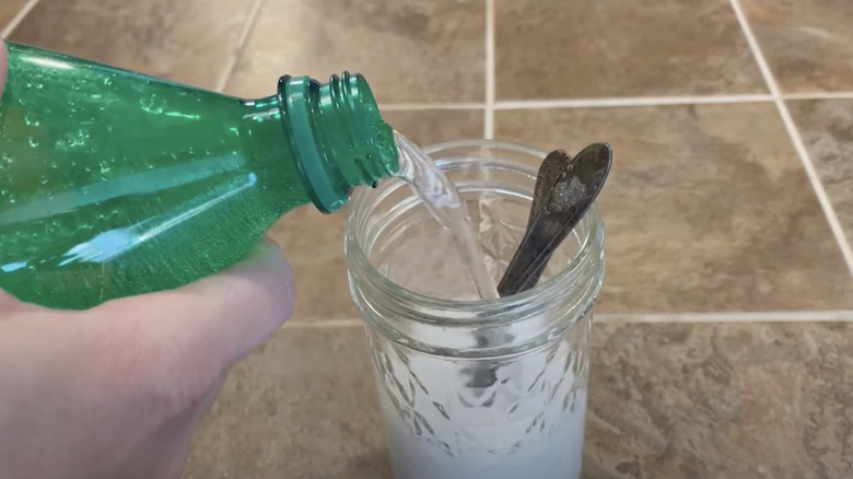 soda pouring over tarnished silverware