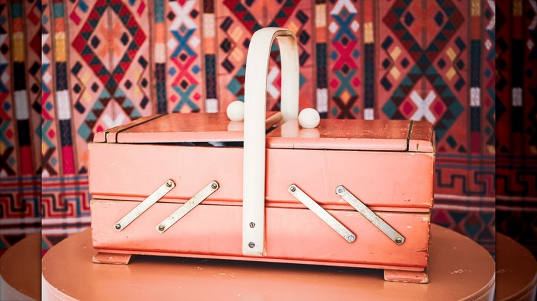 light wooden vintage sewing box with colorful backdrop