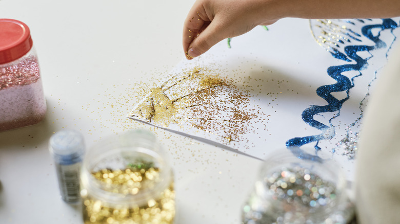 child spilling glitter