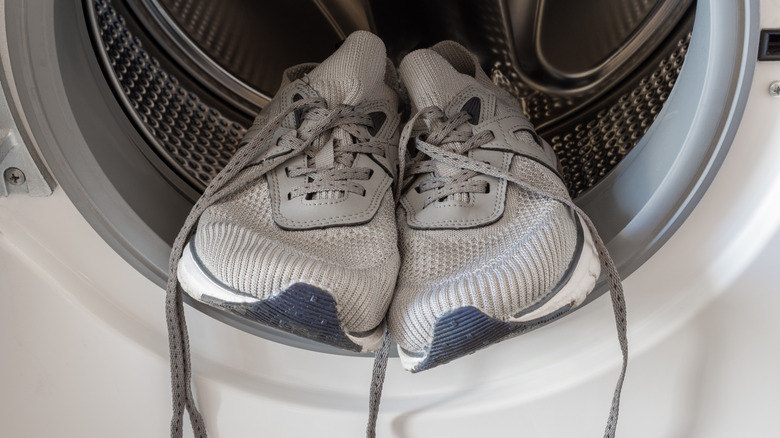 A set of running shoes inside of a dryer.