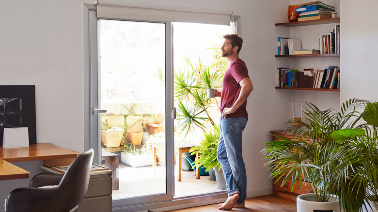 man near sliding glass door