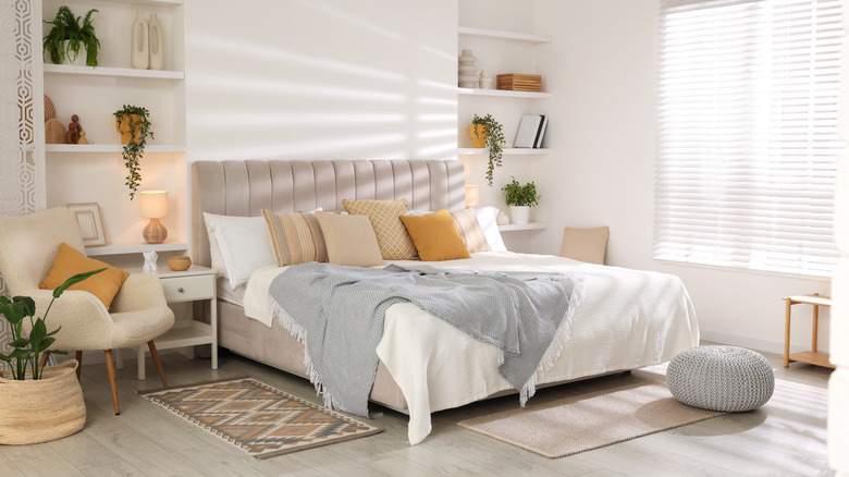 clean bedroom with tidy bed, organized shelves, and decorations