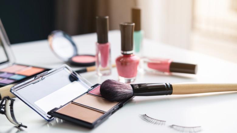 cosmetics and nail polish sitting on vanity with natural sunlight