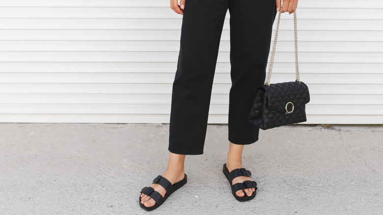 woman wearing black Birkenstocks