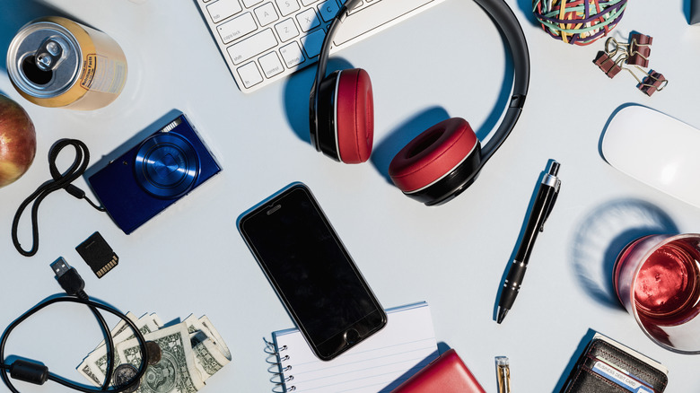 A desk cluttered with various items