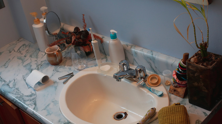 A cluttered bathroom counter