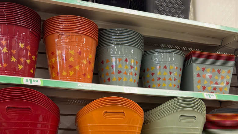 a shelf of Fall leaf print plastic storage bins at Dollar Tree