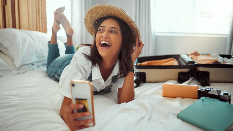 Laughing woman on white bed