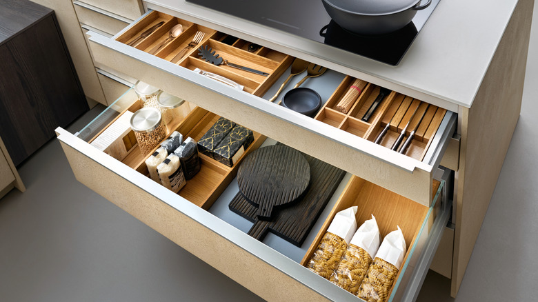 Modern kitchen with open drawers and cutlery inserts