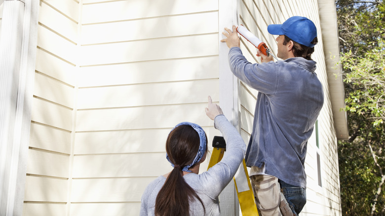 Man using caulk gun