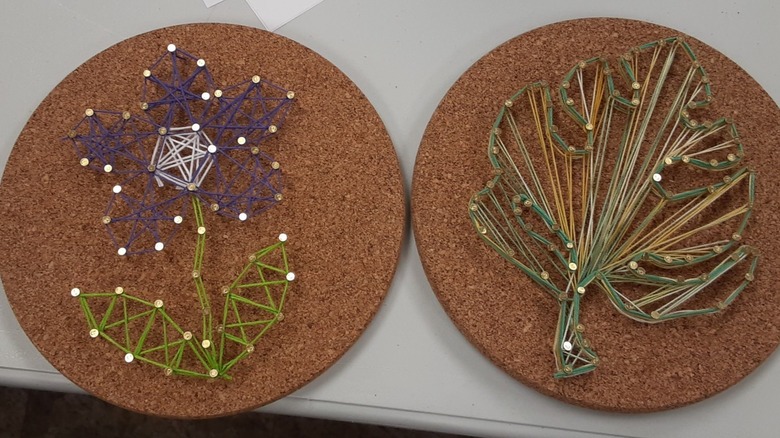 Two art pieces using string art on cork trivets