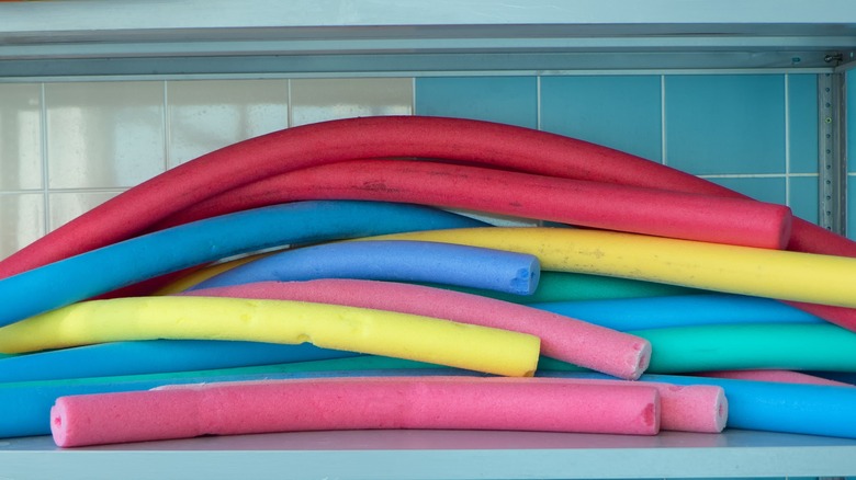 colorful pool noodles on shelf