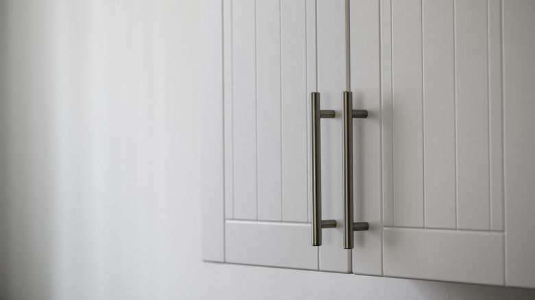 White kitchen cabinets with long pull handles