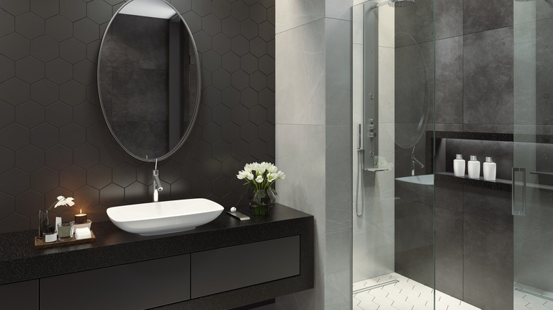 black hexagon tile backsplash in bathroom with gray tile standing shower