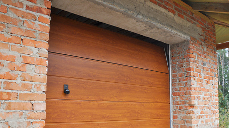 The exterior of a wooden garage door as it opens