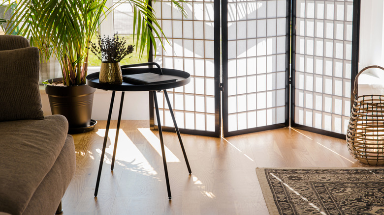 Japanese style paper folding screen room divider in livingroom with plants