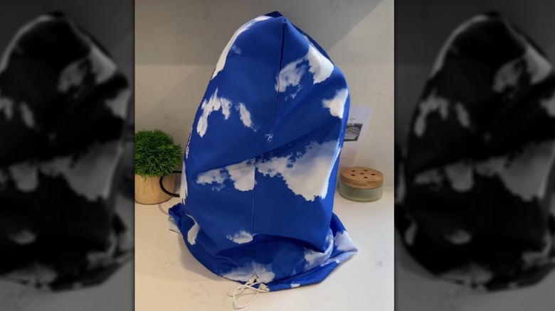 A cloud-themed dust bag used as an appliance cover.
