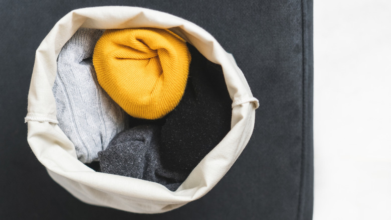 Socks and hats inside a cotton bag.