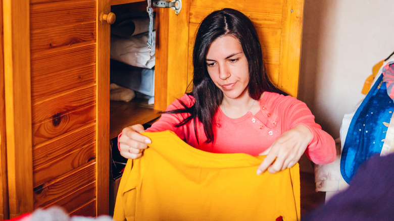 woman looking at t-shirt